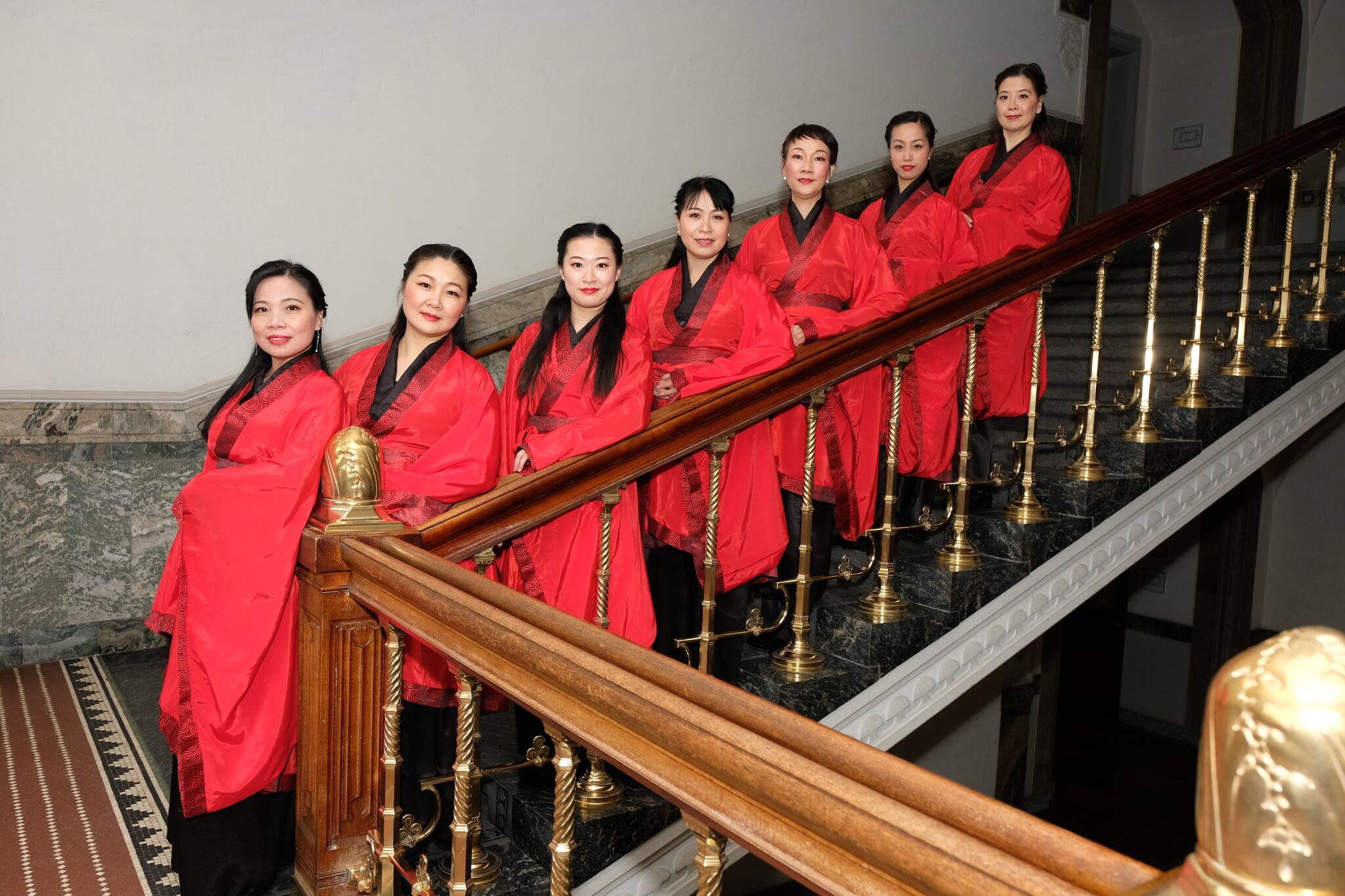 Association members arranged on a staircase in red and black Hanfu