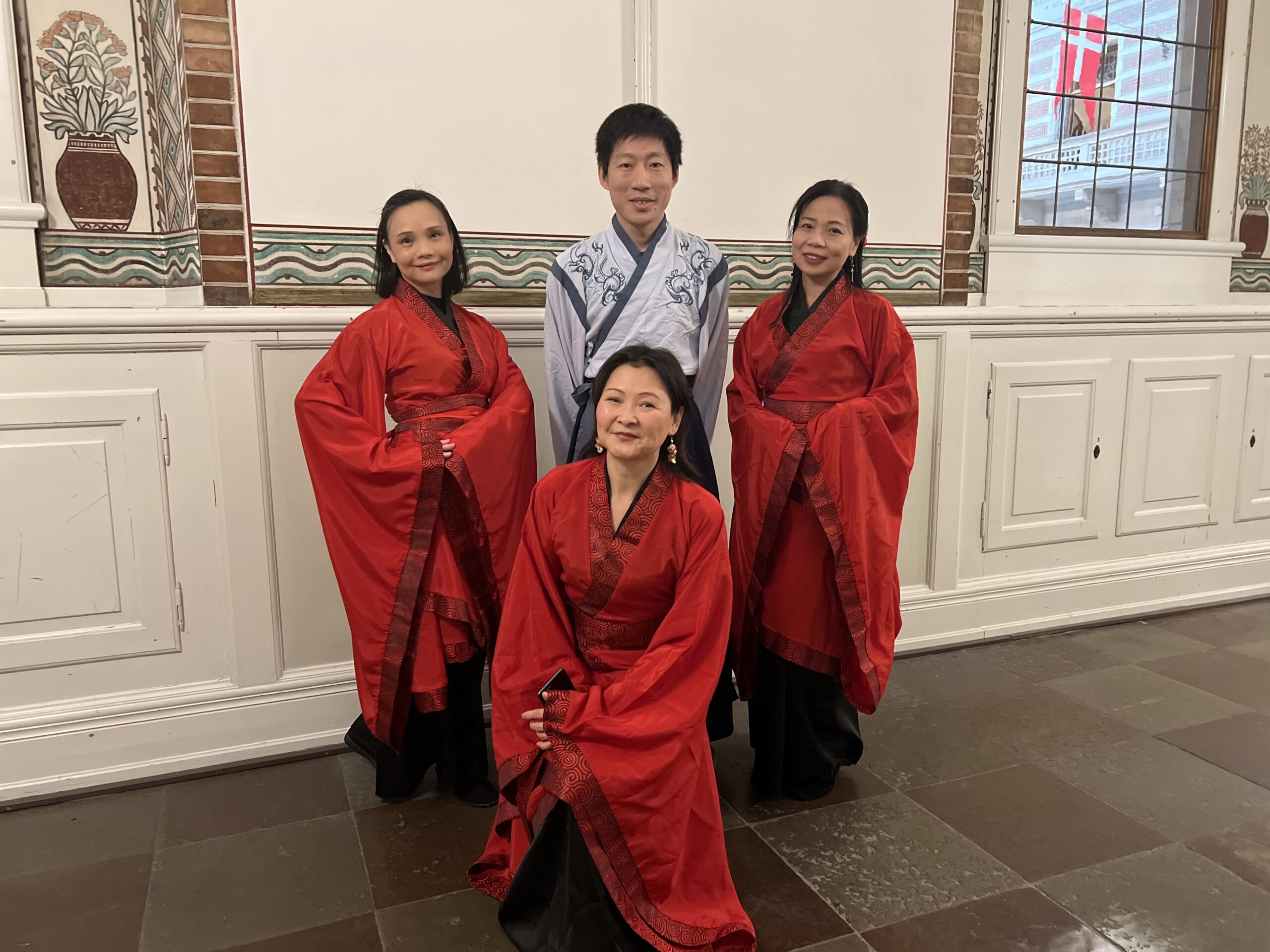 Association members in red and black Hanfu at a gathering