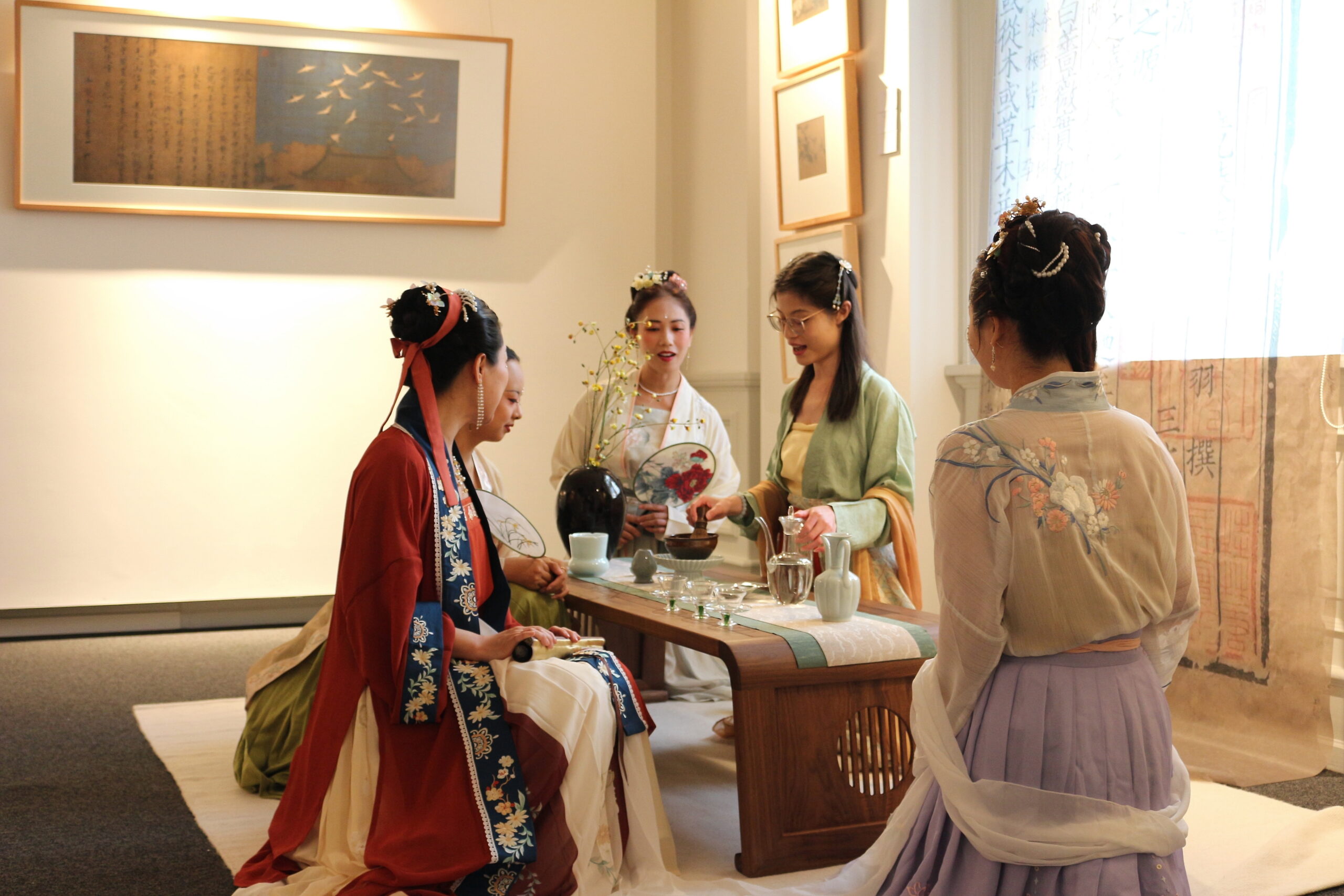Association members presenting Hanfu alongside a traditional tea practice
